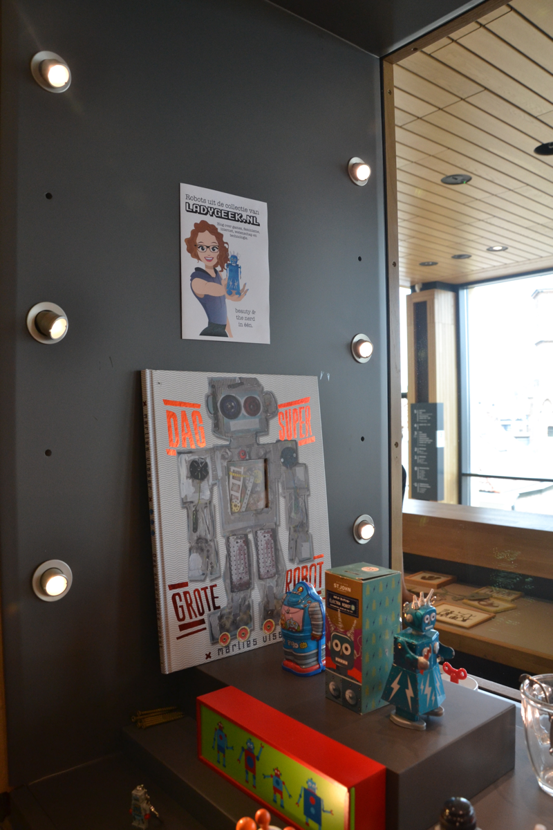 Dag supergrote robot! Boven je staat de Lady Geek-cartoon op wacht.